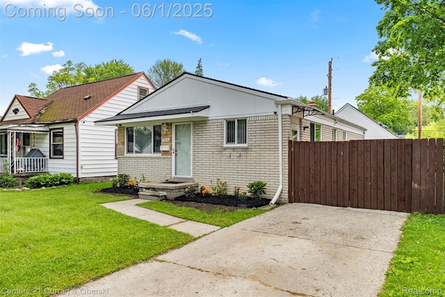 5908 Gilman St, Garden City, MI 48135 - bungalow-style house with board and batten siding, driveway, and brick siding