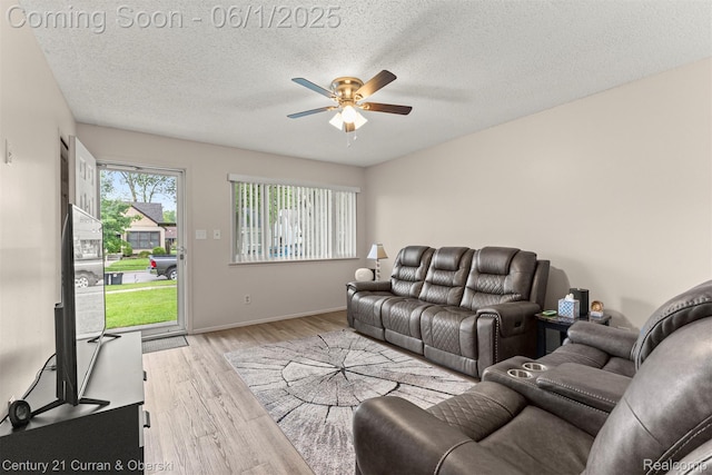 5908 Gilman St, Garden City, MI 48135 - living area with a ceiling fan, wood finished floors, a textured ceiling, and baseboards