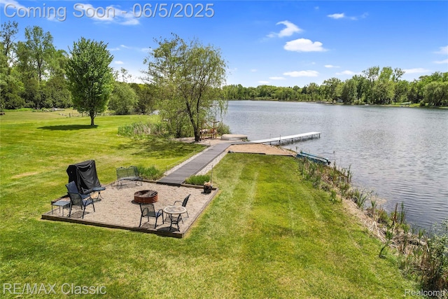 1072 Dunleavy Dr, Highland, MI 48356 - view of green lawn featuring an outdoor fire pit, a boat dock, and a water view
