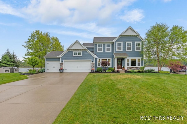 11379 Brielle Ln, Nunica, MI 49448 - view of front of home featuring an attached garage, driveway, a front yard, and stone siding