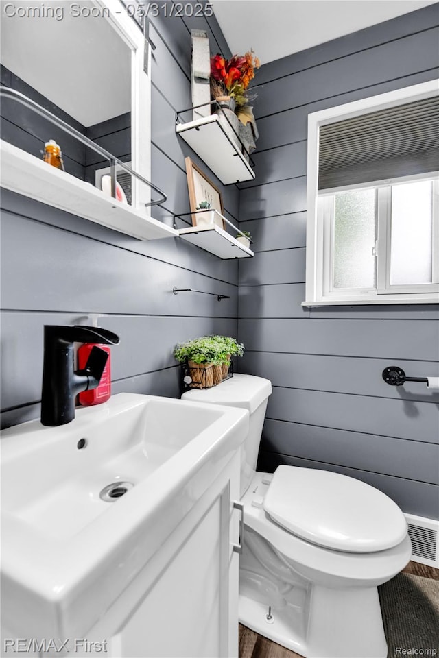 26242 Audrey Ave, Warren, MI 48091 - half bathroom featuring toilet, wood finished floors, and vanity