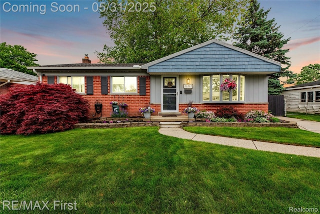 26242 Audrey Ave, Warren, MI 48091 - view of front of house featuring a chimney, brick siding, and board and batten siding