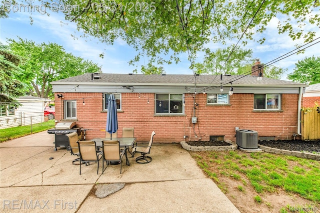 26242 Audrey Ave, Warren, MI 48091 - back of property with central AC, brick siding, a patio area, and a chimney