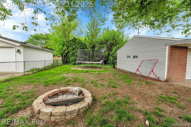 26242 Audrey Ave, Warren, MI 48091 - view of yard with a trampoline and a fire pit