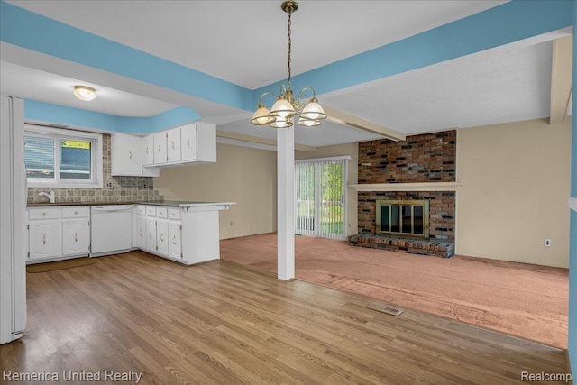 3455 Harmony Dr, Troy, MI 48083 - kitchen featuring open floor plan, dark countertops, light wood-style flooring, a chandelier, and white cabinets