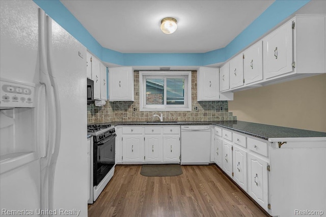 3455 Harmony Dr, Troy, MI 48083 - kitchen featuring white appliances, dark countertops, and white cabinetry