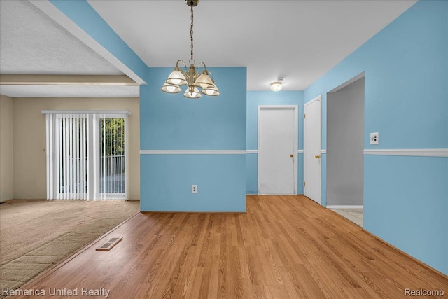 3455 Harmony Dr, Troy, MI 48083 - spare room with a chandelier and wood finished floors