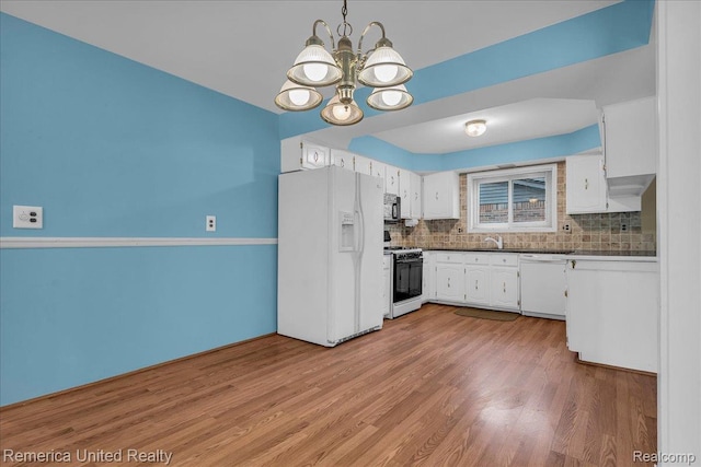 3455 Harmony Dr, Troy, MI 48083 - kitchen featuring white appliances, a chandelier, and white cabinets