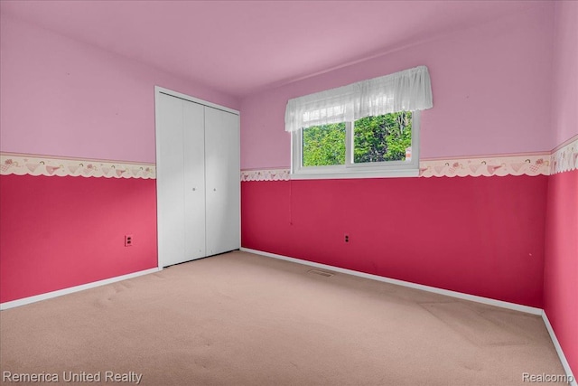 3455 Harmony Dr, Troy, MI 48083 - unfurnished bedroom with carpet, a closet, and wainscoting