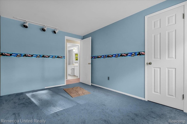 3455 Harmony Dr, Troy, MI 48083 - unfurnished bedroom with rail lighting and carpet floors