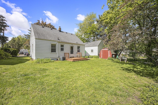 537 Wolverine Dr NE, Grand Rapids, MI 49505 - rear view of property featuring a wooden deck, a lawn, a chimney, and roof with shingles