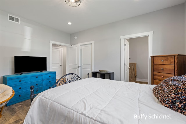 334 Terrace Point Cir Unit 33, Muskegon, MI 49440 - bedroom featuring wood finished floors, recessed lighting, and connected bathroom