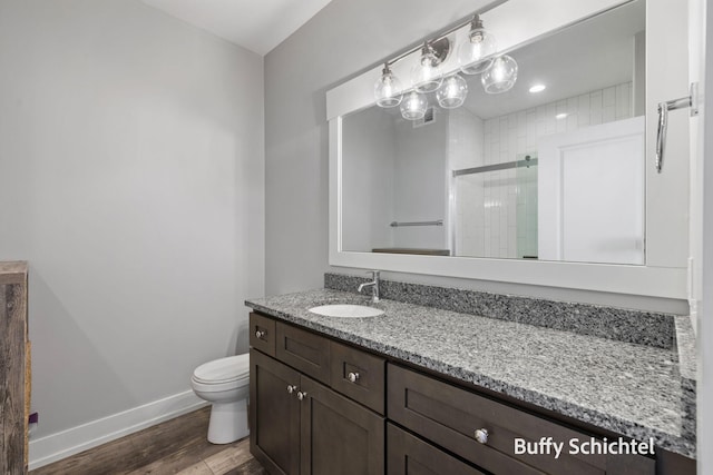 334 Terrace Point Cir Unit 33, Muskegon, MI 49440 - full bath with vanity, a stall shower, wood finished floors, toilet, and baseboards