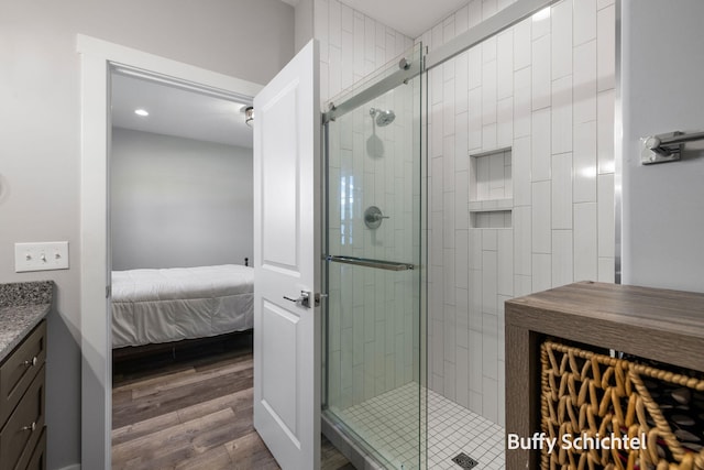 334 Terrace Point Cir Unit 33, Muskegon, MI 49440 - ensuite bathroom featuring wood finished floors, vanity, a shower stall, and recessed lighting