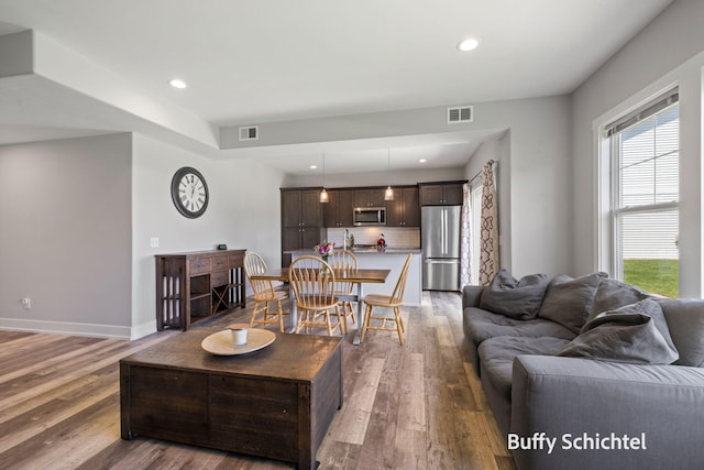 334 Terrace Point Cir Unit 33, Muskegon, MI 49440 - living area featuring wood finished floors, plenty of natural light, baseboards, and recessed lighting