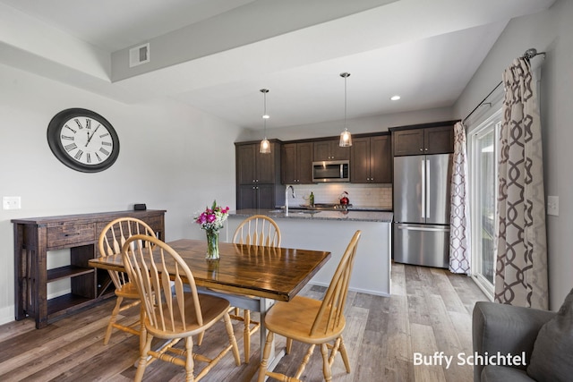 334 Terrace Point Cir Unit 33, Muskegon, MI 49440 - dining room featuring wood finished floors and recessed lighting