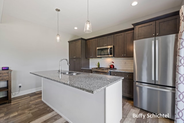 334 Terrace Point Cir Unit 33, Muskegon, MI 49440 - kitchen featuring stainless steel appliances, a sink, dark brown cabinets, a center island with sink, and dark wood-style flooring