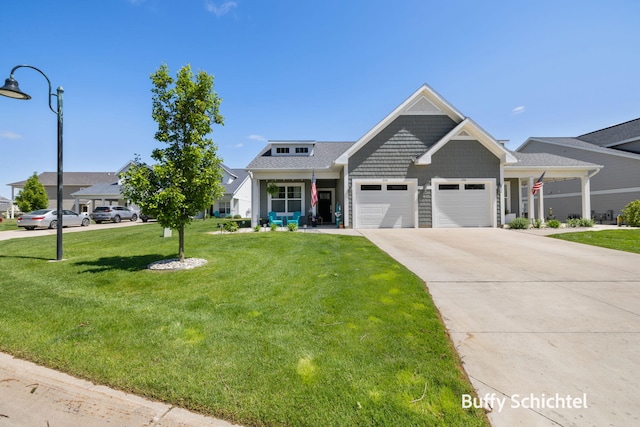 334 Terrace Point Cir Unit 33, Muskegon, MI 49440 - view of front facade with a front lawn, a garage, and concrete driveway