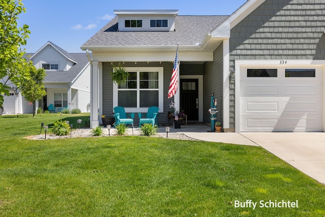 334 Terrace Point Cir Unit 33, Muskegon, MI 49440 - view of front of property with covered porch, a garage, roof with shingles, a front lawn, and driveway
