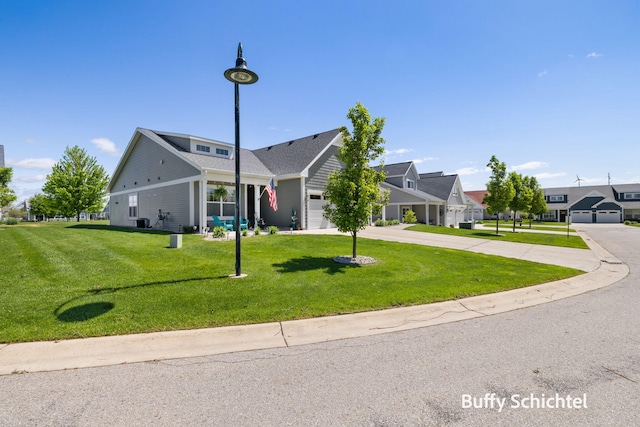 334 Terrace Point Cir Unit 33, Muskegon, MI 49440 - view of front of home with concrete driveway, a front yard, an attached garage, and a residential view