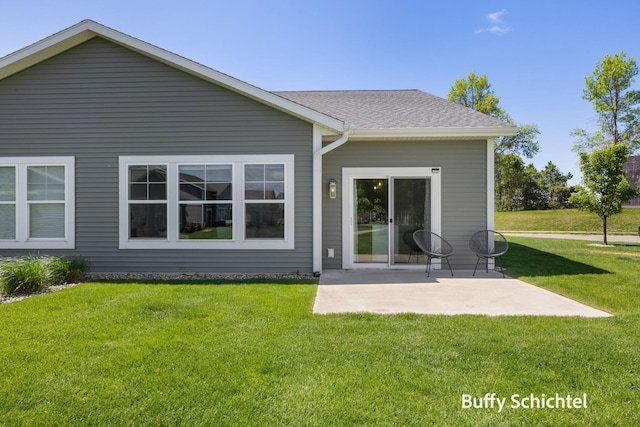 334 Terrace Point Cir Unit 33, Muskegon, MI 49440 - rear view of property featuring a patio area, a yard, and roof with shingles