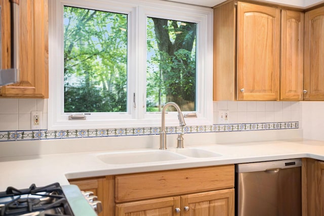 3509 Sulgrave Pl, Ann Arbor, MI 48105 - kitchen featuring stainless steel dishwasher, a sink, light countertops, and tasteful backsplash