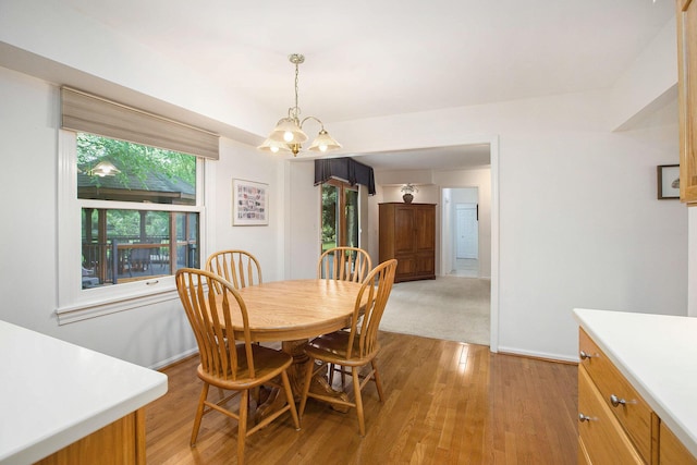 3509 Sulgrave Pl, Ann Arbor, MI 48105 - dining space with light wood finished floors, a chandelier, and baseboards