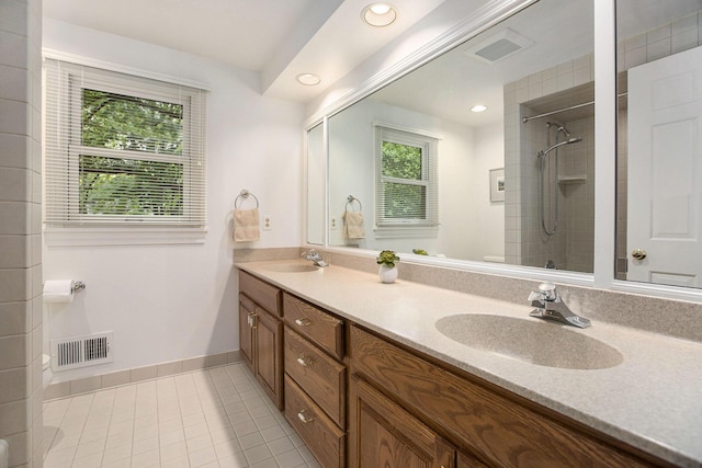 3509 Sulgrave Pl, Ann Arbor, MI 48105 - bathroom featuring double vanity, a tile shower, tile patterned floors, baseboards, and recessed lighting