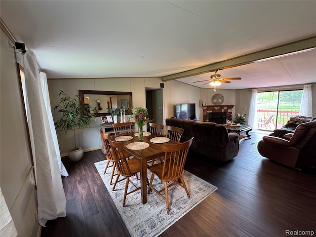 6858 W Emery Rd, Houghton Lake, MI 48629 - dining room with ceiling fan, a stone fireplace, and wood finished floors
