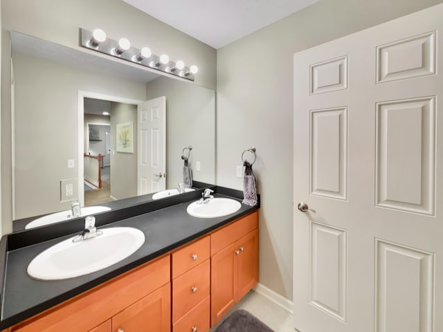 4315 Astoria Ave SE, Grand Rapids, MI 49512 - bathroom featuring double vanity and baseboards