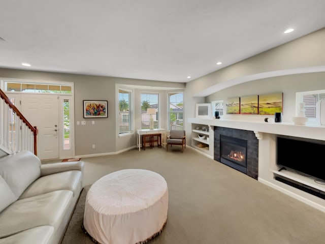 4315 Astoria Ave SE, Grand Rapids, MI 49512 - living room featuring carpet floors, recessed lighting, a tile fireplace, stairs, and baseboards