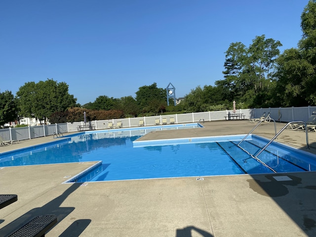 4315 Astoria Ave SE, Grand Rapids, MI 49512 - community pool featuring a patio and view of scattered trees