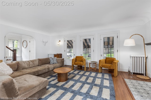 1377 Bishop Rd, Grosse Pointe Park, MI 48230 - living area featuring arched walkways, radiator heating unit, and wood finished floors