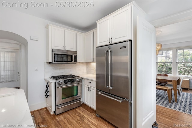 1377 Bishop Rd, Grosse Pointe Park, MI 48230 - kitchen with appliances with stainless steel finishes, light wood finished floors, light countertops, and white cabinetry