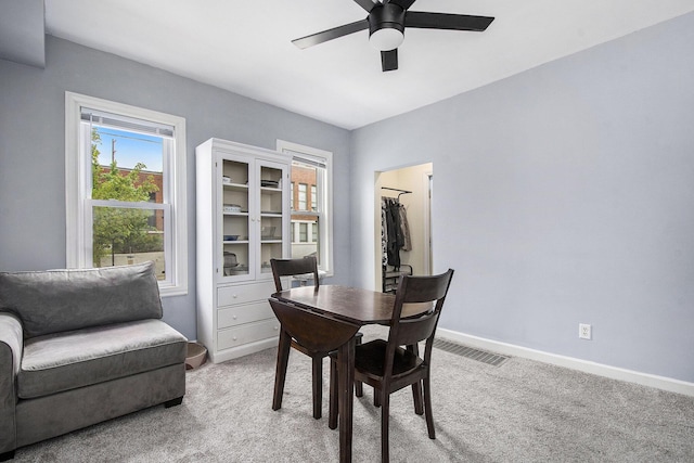 928 Baxter St SE, Grand Rapids, MI 49506 - dining space featuring a ceiling fan, light colored carpet, and baseboards