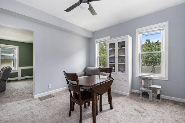 928 Baxter St SE, Grand Rapids, MI 49506 - dining room featuring light carpet, ceiling fan, and baseboards