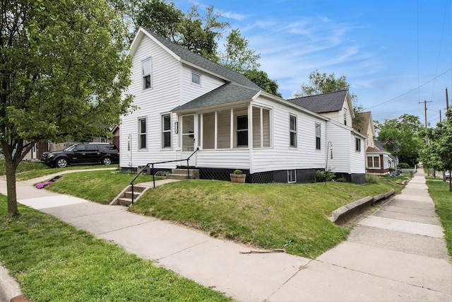 928 Baxter St SE, Grand Rapids, MI 49506 - view of front facade featuring roof with shingles and a front yard