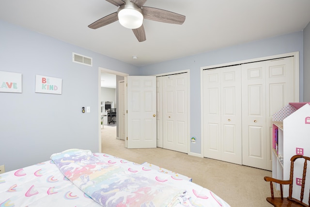 1743 Savannah Ln, Ypsilanti, MI 48198 - bedroom with multiple closets, light carpet, and ceiling fan