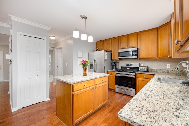 1743 Savannah Ln, Ypsilanti, MI 48198 - kitchen featuring appliances with stainless steel finishes, a sink, crown molding, light wood-style flooring, and decorative backsplash