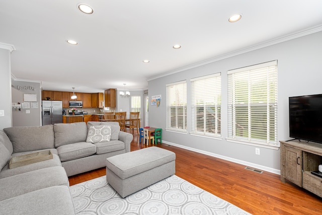 1743 Savannah Ln, Ypsilanti, MI 48198 - living area featuring crown molding, recessed lighting, baseboards, a chandelier, and wood finished floors