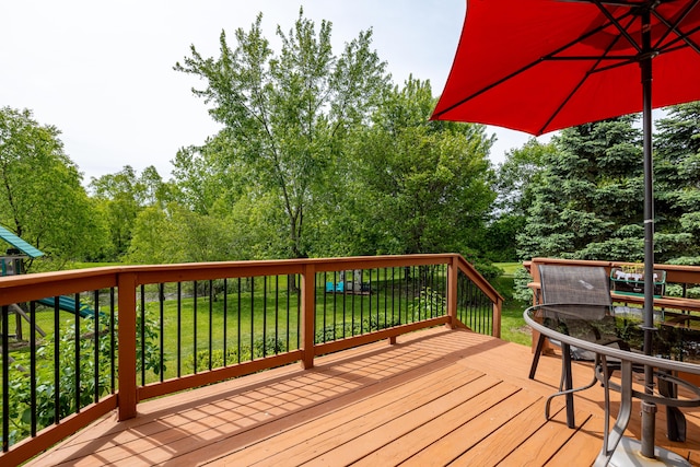 1743 Savannah Ln, Ypsilanti, MI 48198 - wooden deck with a lawn, outdoor dining space, and view of wooded area