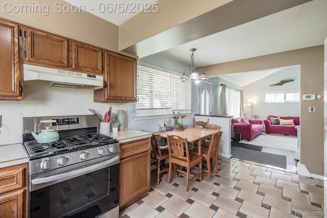 36335 Weideman St, Clinton Township, MI 48035 - kitchen featuring stainless steel gas range, under cabinet range hood, brown cabinets, light countertops, and vaulted ceiling