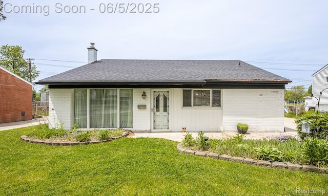 36335 Weideman St, Clinton Township, MI 48035 - view of front facade featuring brick siding, a front lawn, a chimney, and roof with shingles
