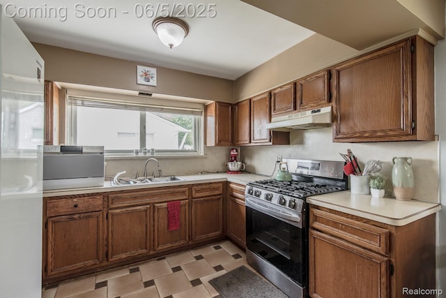 36335 Weideman St, Clinton Township, MI 48035 - kitchen featuring gas stove, under cabinet range hood, a sink, light countertops, and brown cabinetry