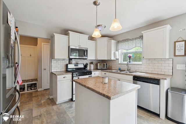 9416 Sunrise Ln, Davison, MI 48423 - kitchen with stainless steel appliances, a sink, decorative backsplash, and white cabinetry