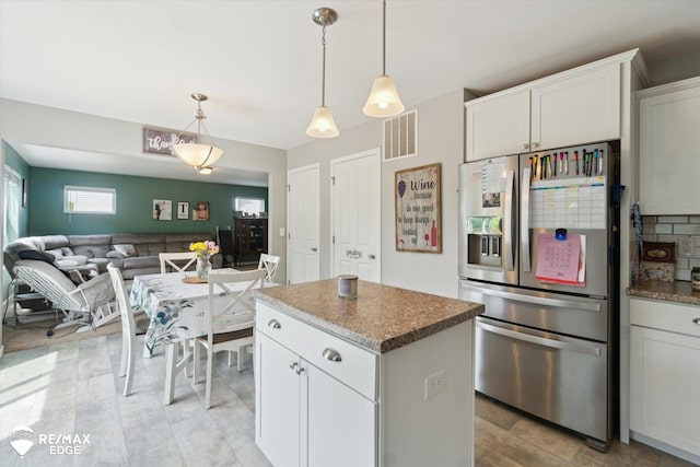 9416 Sunrise Ln, Davison, MI 48423 - kitchen with stainless steel refrigerator with ice dispenser, a center island, pendant lighting, white cabinetry, and open floor plan