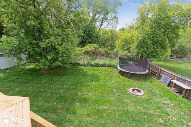 9416 Sunrise Ln, Davison, MI 48423 - view of yard featuring a trampoline and an outdoor fire pit