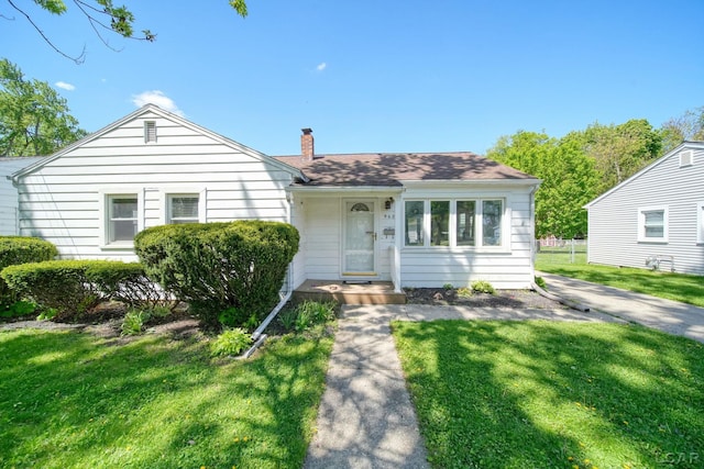 962 Vine St, Adrian, MI 49221 - view of front of house with a chimney and a front lawn