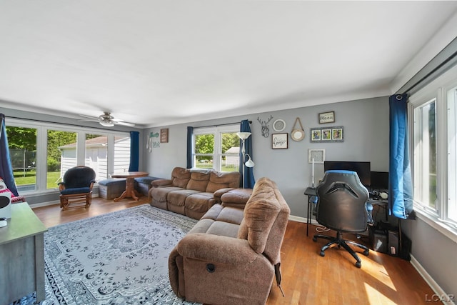 962 Vine St, Adrian, MI 49221 - living area featuring wood finished floors, a desk, a ceiling fan, and baseboards