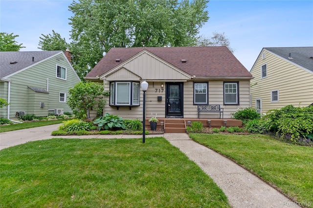 717 N Vermont Ave, Royal Oak, MI 48067 - bungalow-style home featuring a front lawn, board and batten siding, and a shingled roof